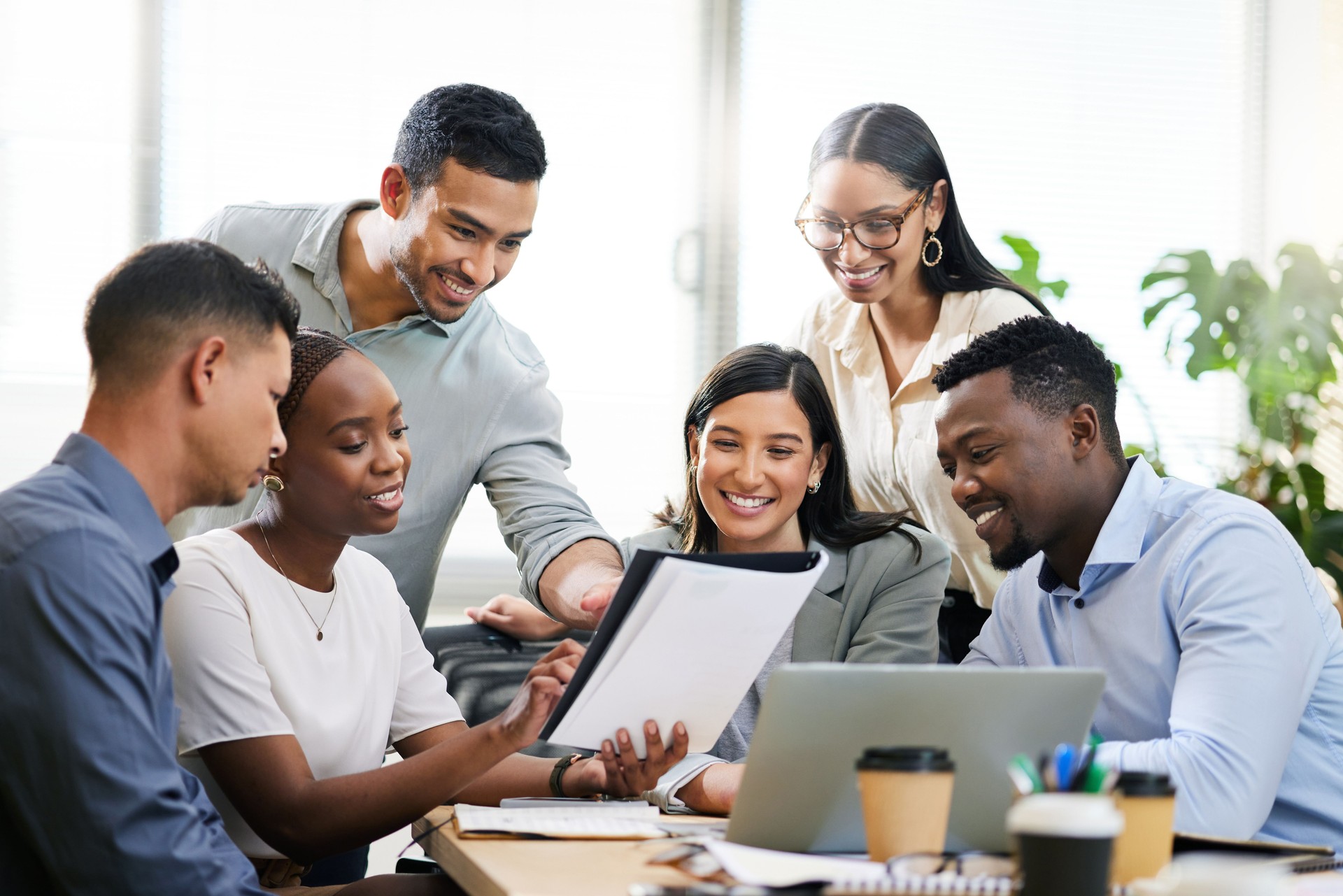 Cropped shot of a diverse group of businesspeople sitting in the boardroom during a meeting